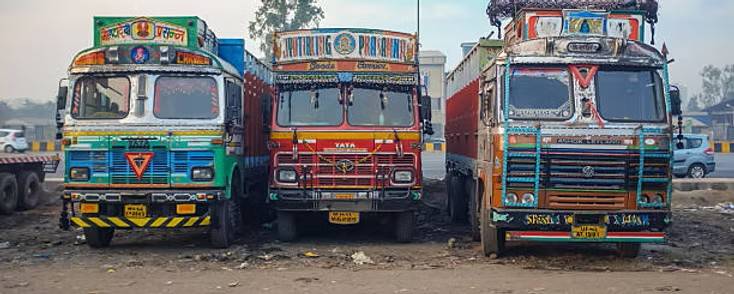 Mastering the First Impression: Your intriguing post title goes here Row of three vibrantly decorated Indian trucks parked, showcasing traditional truck art