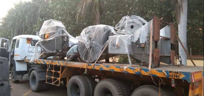 Securely wrapped and chained industrial goods loaded on a transport trailer